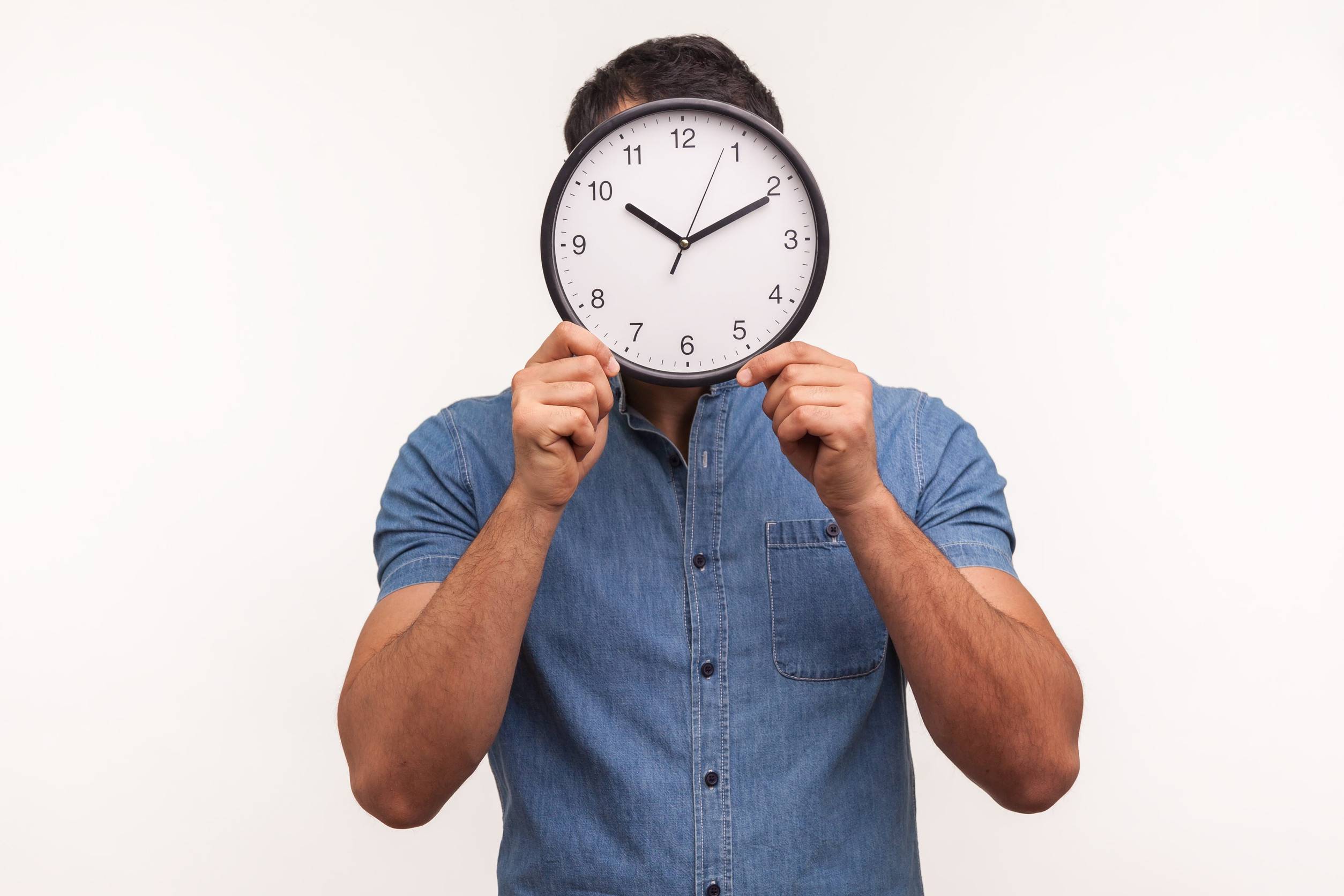 A Man Holding A Clock