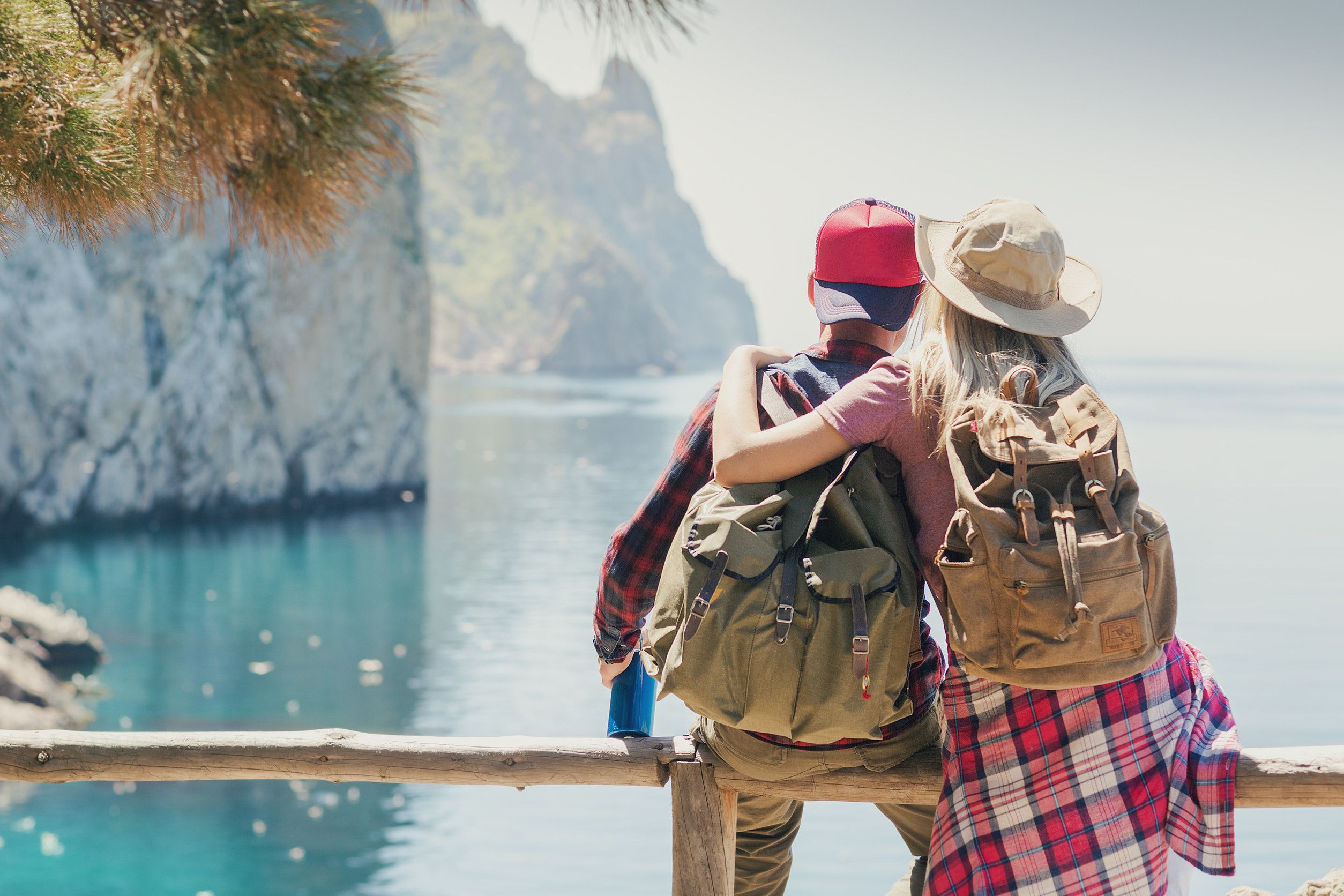 Couple with backpacks enjoying seaside view